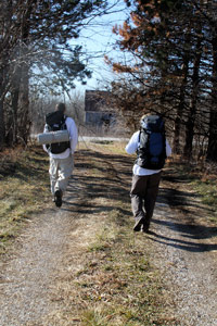 Two walking down trail photo
